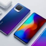 A Realme smartphone with a colorful display, its back shown alongside, next to white wireless earbuds and a case on a white surface.