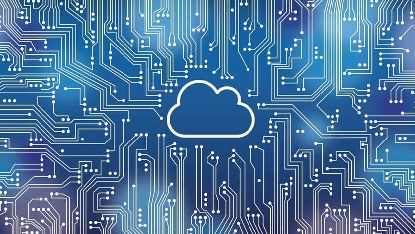 Illustration of a cloud icon at the center of a blue circuit board background representing cloud computing technology.