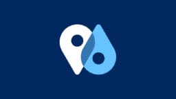 A white map pin icon of GeoPostcodes.com website overlapping with a blue water droplet icon, both featuring circular cutouts, on a dark blue background.