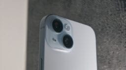 Close-up of the back of a white smartphone showing two camera lenses and a flash module.