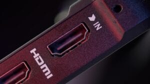 Close-up of an HDMI port labeled IN on an electronic device, with visible connector pins and a surrounding red and black casing.