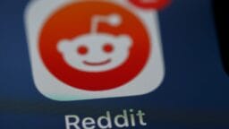 Close-up of the Reddit app icon on a screen with a notification badge showing the number 2.