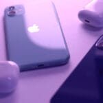 Two iPhones and two AirPods cases are placed on a flat surface under purple lighting.