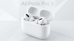White AirPods Pro 3 earbuds rest in their open charging case against a light gray geometric background.