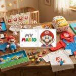 A wooden table displays various Super Mario-themed toys, clothes, and accessories in a nursery with a crib and window in the background.