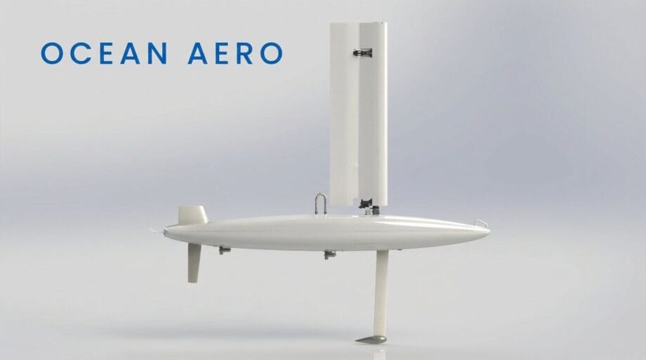 A white autonomous sail-powered marine drone with a vertical sail and rudder, labeled Ocean Aero on a plain background.