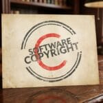 A document labeled Software Copyright with a large red copyright symbol sits on a wooden desk in a library setting.