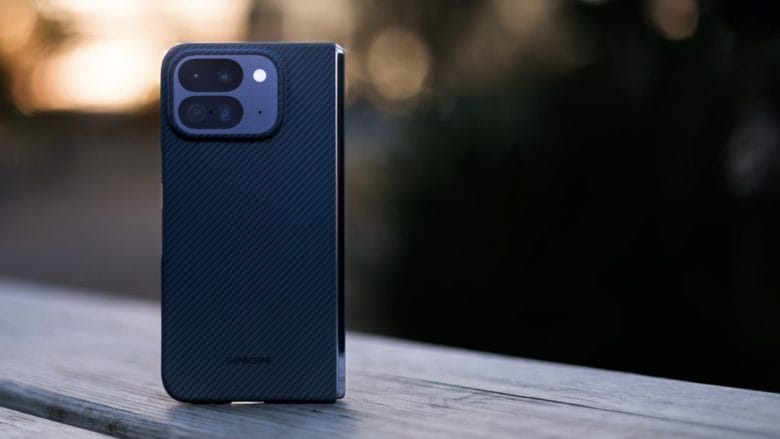 A Pixel 10 Pro smartphone with Thinborne fold case is standing upright on a wooden surface with a blurred background.