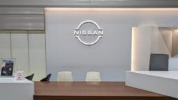 a conference room with a nissan logo on the wall