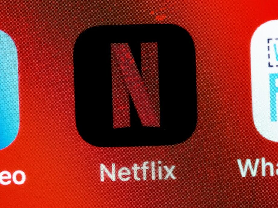 Close-up of the Netflix app icon on a screen, displaying a red N on a black background with Netflix written below.