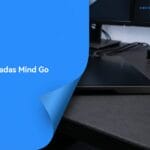 A Khadas Mind Go computer on a desk next to monitors and other electronic devices, with Khadas Mind Go text on a blue overlay.