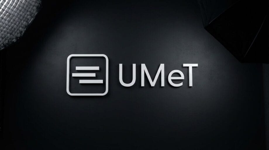 UMeT logo on a dark wall, with studio lighting equipment partially visible in the corners.