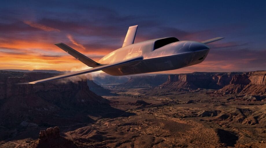 A sleek, futuristic jet flies over a rocky desert canyon at sunset with dramatic clouds in the sky.
