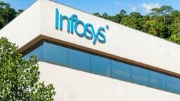 The Infosys logo is displayed on the upper corner of a modern office building with trees in the background.