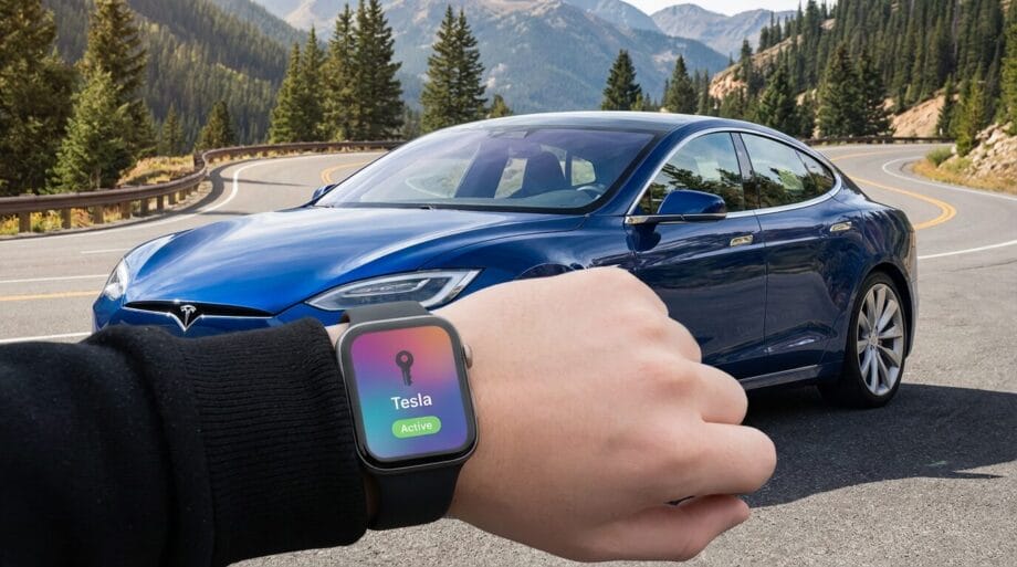 A person holds up a smartwatch displaying Tesla Active near a blue Tesla car parked on a mountain road.