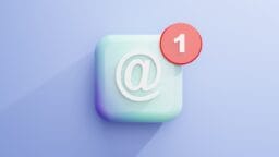 A 3D icon with an at symbol and a red notification badge displaying the number 1 on a light blue background.