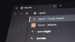 A computer screen showing a web browser with quora entered in the search bar and related search suggestions below.