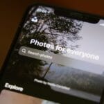 A smartphone screen displays a photo app with a search bar reading Photos for everyone and an outdoor background image.