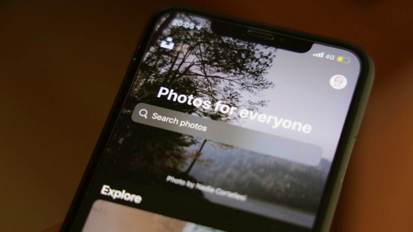 A smartphone screen displays a photo app with a search bar reading Photos for everyone and an outdoor background image.