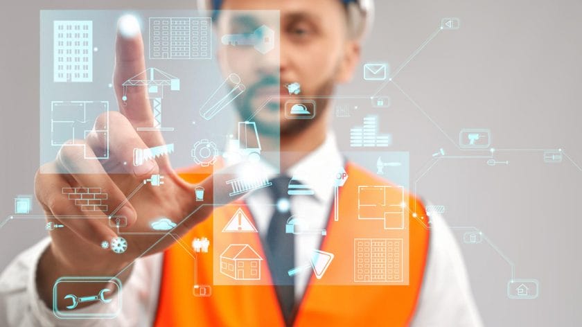 A person in a hard hat and orange vest interacts with virtual construction-related icons on a transparent digital interface with computer vision technology.