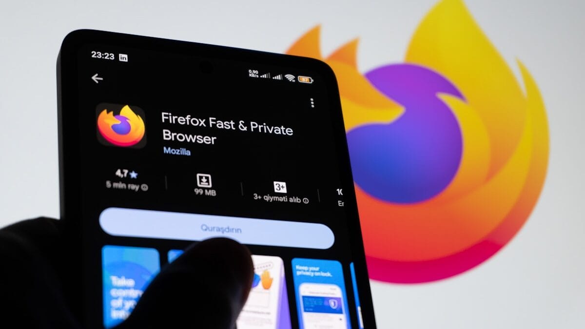 A smartphone displays the Firefox browser app page on Google Play, with a large Firefox logo in the background.