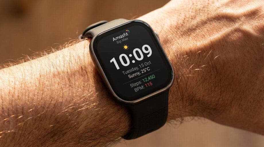 A smartwatch on a persons wrist displays the time, date, weather, step count, and heart rate on its home screen.