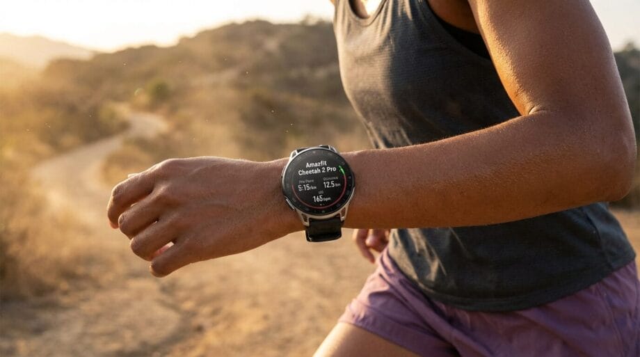 Person jogging on a dirt trail while wearing a smartwatch that displays fitness data on their wrist.