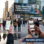 People in a city square use smartphones, with a billboard reading Global Smartphone Trends: Connecting a World in Motion in the background.