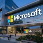 Modern Microsoft office building with large logo, glass facade, and people walking outside in an urban business setting.