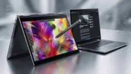 A convertible laptop in tent mode displays digital art with a stylus, next to an open laptop showing a webpage on a metallic surface.